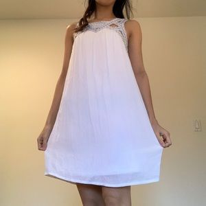 White dress with high neckline & blue embroidery